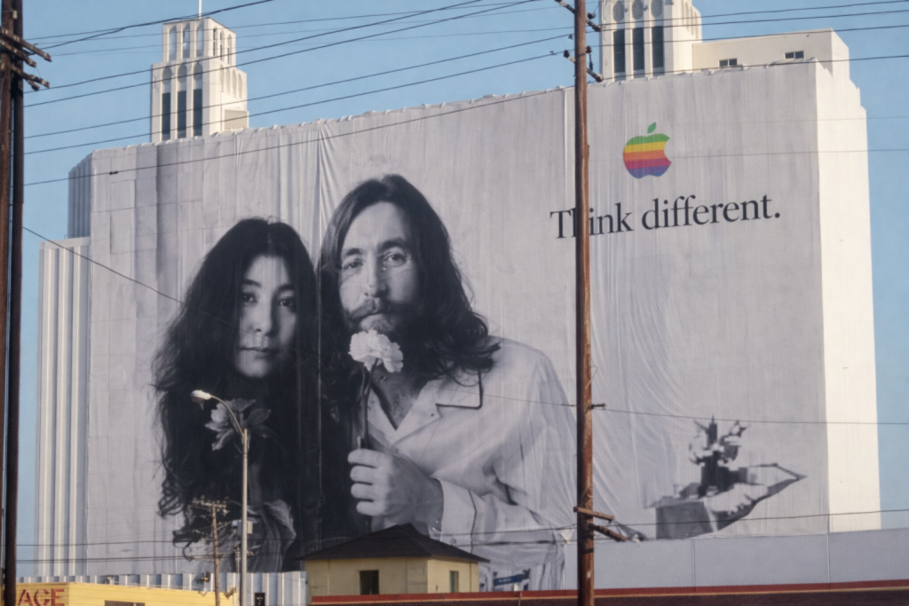 Large black and white Apple billboard featuring Think Different message on a building facade
