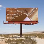 Tower 28 beauty billboard with “This is a swipe you won’t regret” messaging in desert outdoor advertising setting