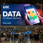 A large digital airport advertising display featuring MX branding and the message “DATA for Better Banking” above a busy airport terminal area. The advertisement includes a smartphone visual and high-visibility digital signage designed to capture the attention of travelers in a high-footfall airport environment.