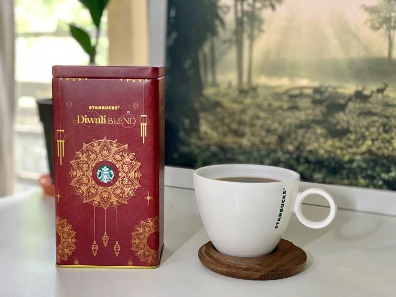 This image shows a Diwali Blend box with a cup of coffee from Starbucks
