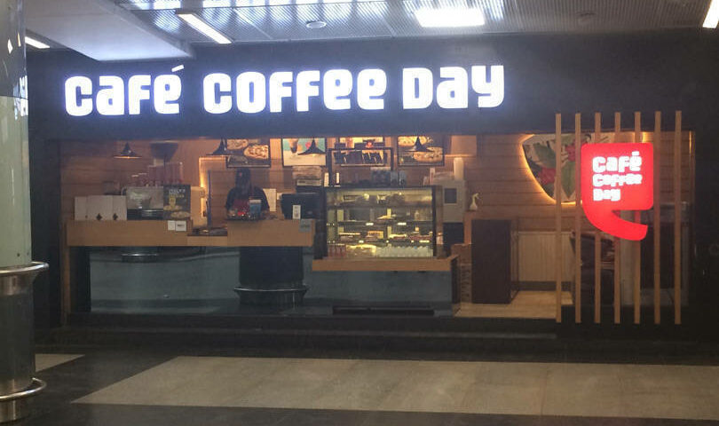 This image shows a Cafe Coffee Day outlet at a busy place