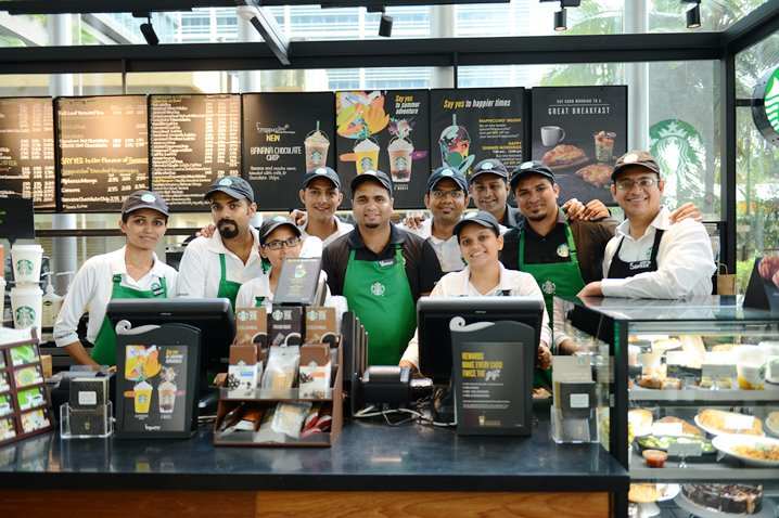This image shows happy and diverse staff working at Starbucks