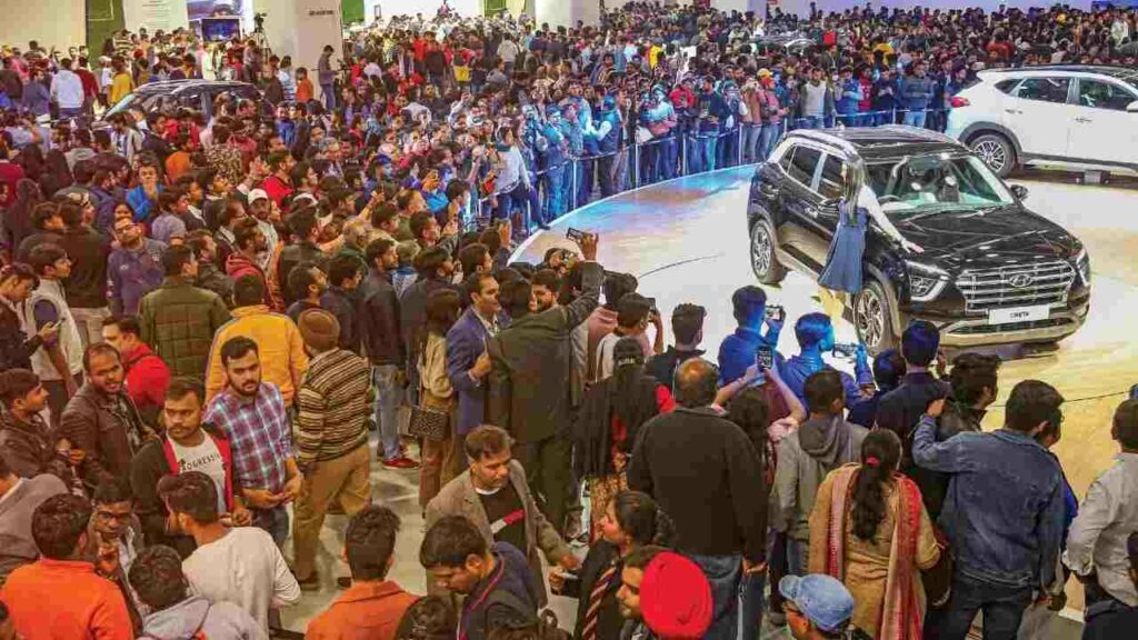This image shows an auditorium with people on a car launch