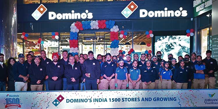 This image shows people from Domino's coming together to celebrate the 1500th store opening of Domino’s