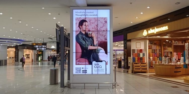 This image depicts advertisements on a digital billboard in a mall