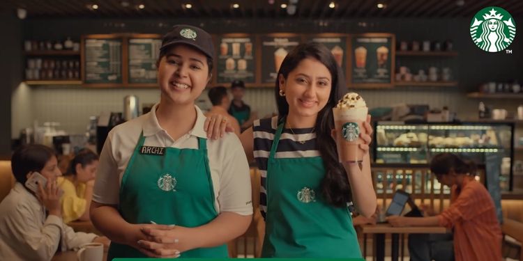 This image shows a Starbucks employee with a customer who made her personalised beverage at Starbucks