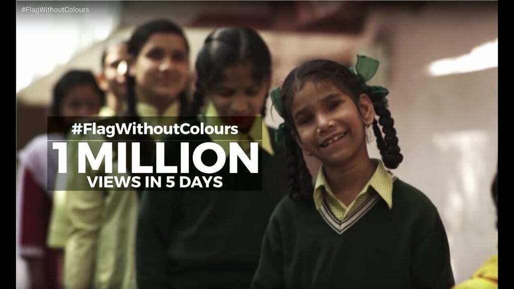 This image features a visually challenged girl in a school uniform in the “Flag Without Colours” campaign of MP Birla Cement