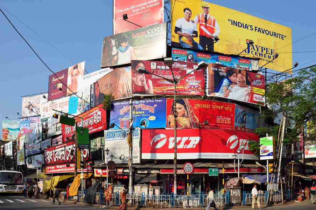 Large billboards at a marketplace cluttered as a huge junk of ads