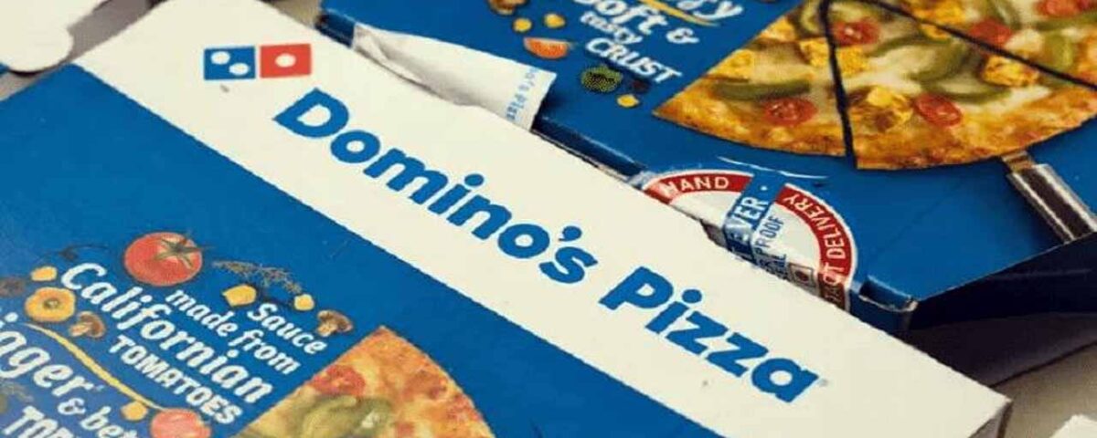 This picture depicts two pizza boxes with the branding of Domino’s Pizza