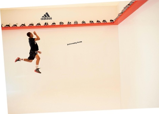 This image shows a picture of Derrick Rose jumping into an Adidas store with the slogan Just Browsing, Thanks!

