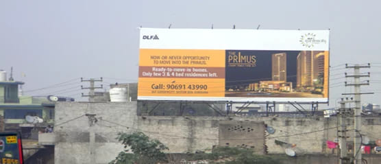 This image displays an ad on a billboard for DLF properties

