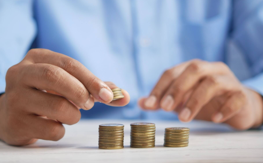 Picture showing a man and some coins