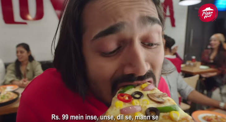  It shows the youtuber celebrity eating pizza
