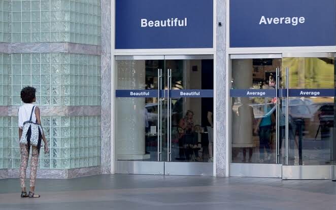 A woman is faced with two signs  beautiful and average and has to choose one
