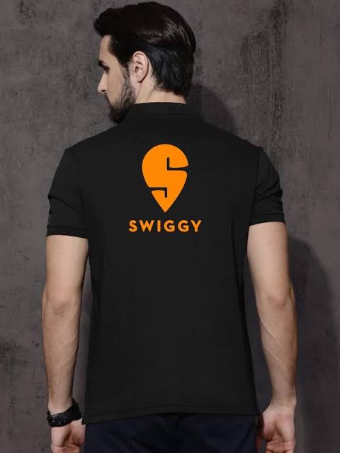 The picture shows swiggy staff wearing the brand T Shirt
