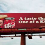 A cold drink advertisement on a billboard.