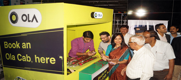 People queueing to book cabs from the Ola taxi kiosk