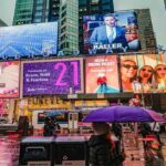 Creative and minimalistic billboards being displayed in a busy street.