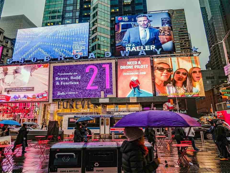 Creative and minimalistic billboards being displayed in a busy street.