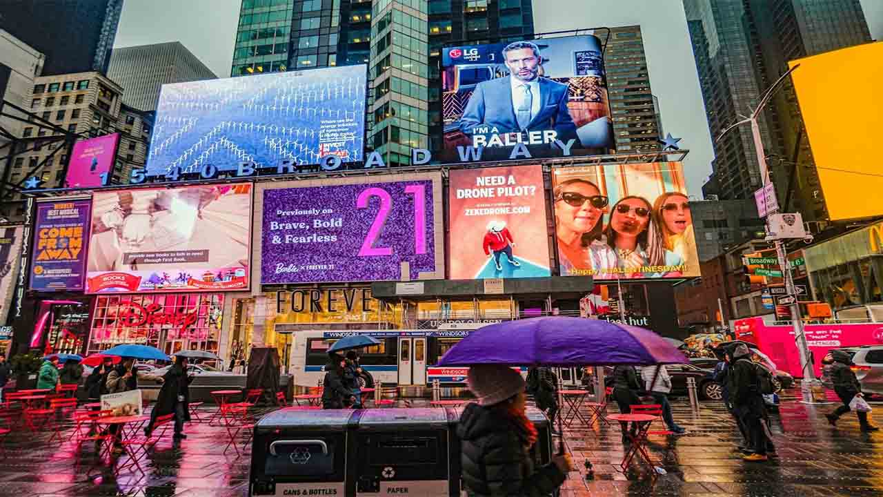 Creative and minimalistic billboards being displayed in a busy street.