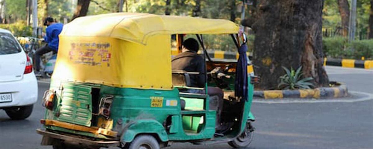 An auto featuring a poster advertisement on its rear side.