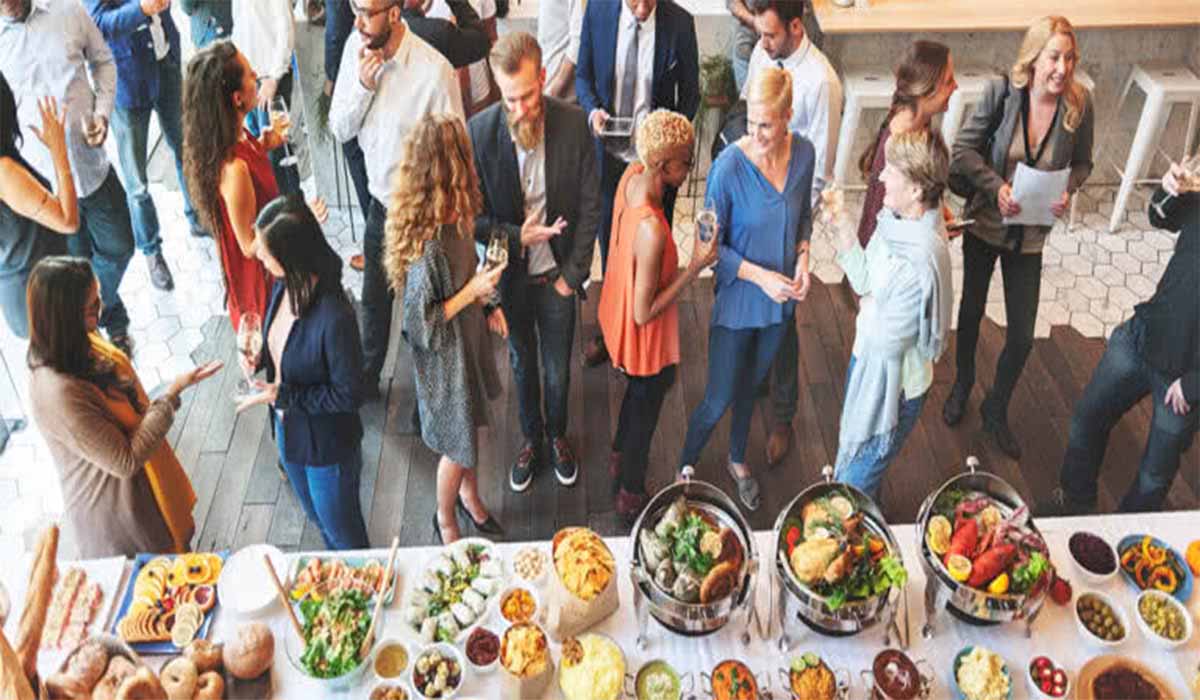  A man filling his plate with food at an event.
