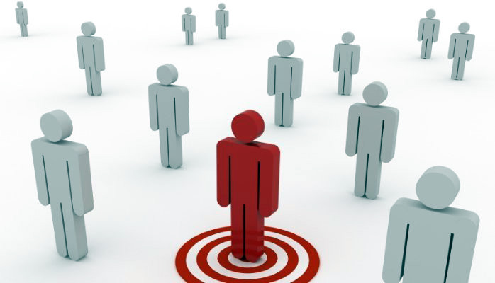 A picture featuring various grey-coloured human-like figures and only one red human figure within a target circle.
