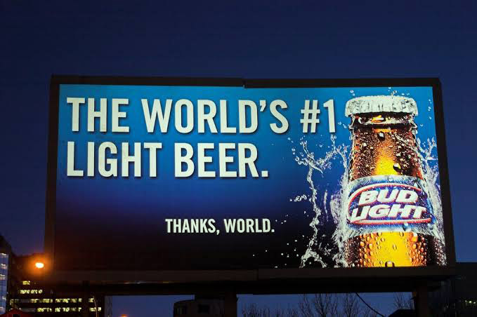 A backlit Billboard advertising beer.

