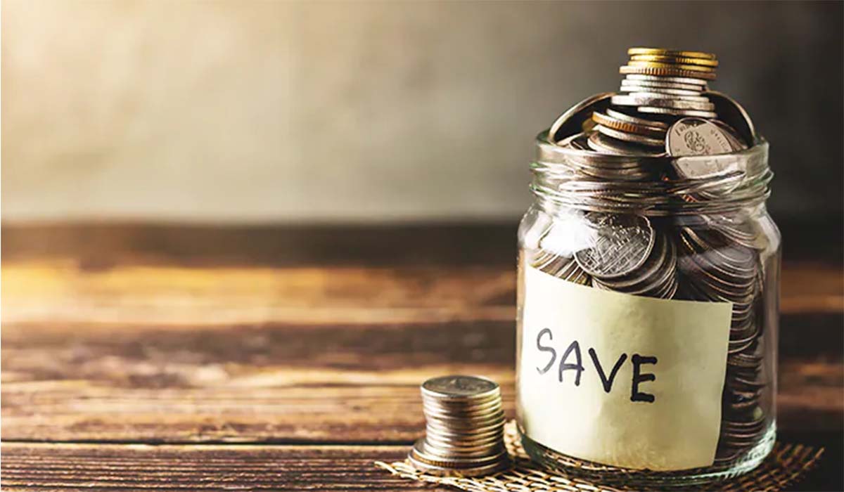 A glass jar with the tag “save” used to save money (coins).
