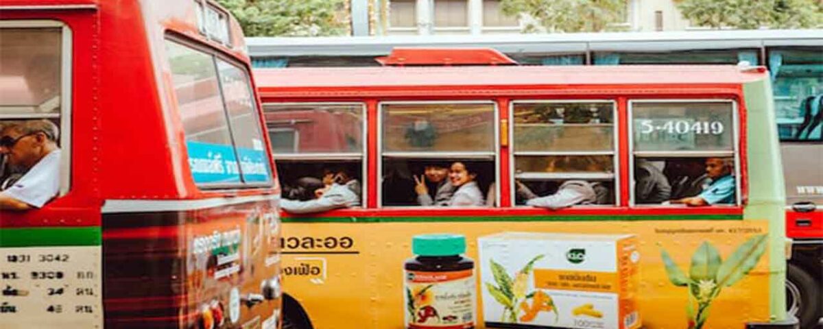 A public bus featuring the advertisement of a popular pharma brand.