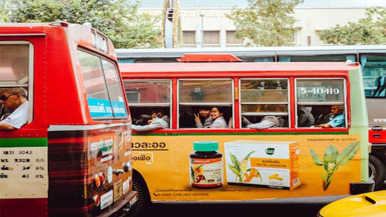 A public bus featuring the advertisement of a popular pharma brand.