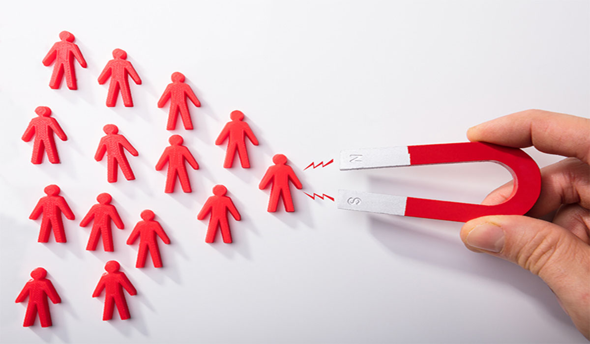  A magnet is used to attract human figures.

