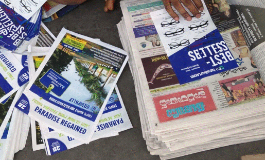 Stack of printed newspaper flyers and paper inserts used for local promotions