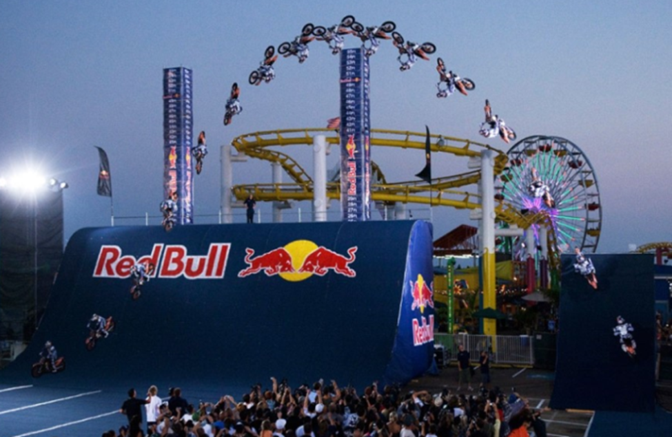 Red Bull branded stunt event setup with bikes and crowd engagement at an outdoor venue