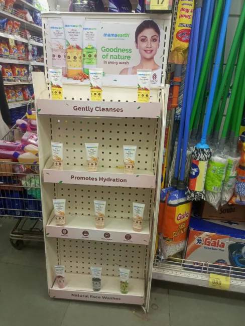 Mamaearth skincare products displayed on branded retail shelf inside a supermarket