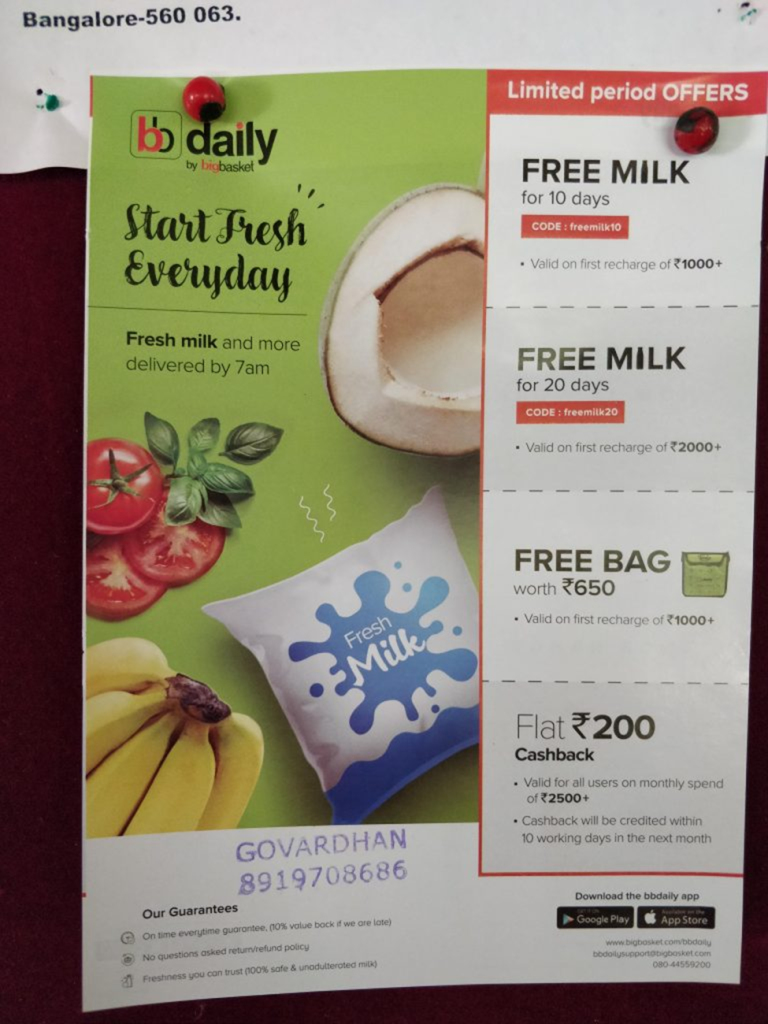 Printed promotional flyer pinned on a board advertising daily milk delivery offers