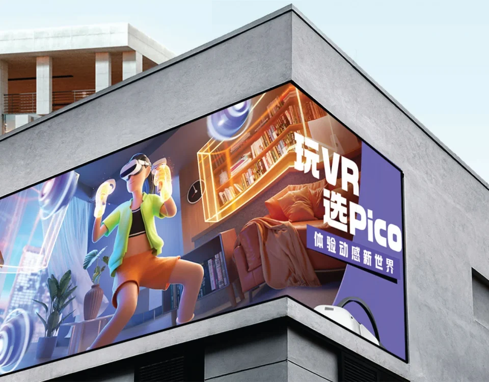 Corner-mounted digital billboard on a modern building displaying an immersive VR gaming advertisement featuring a person using a virtual reality headset.