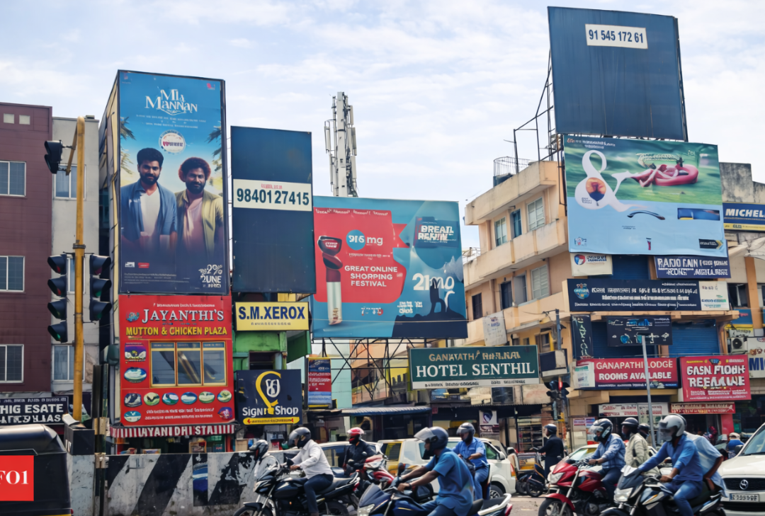 Dense Billboard Cluster At Busy Urban Intersection Crowded city intersection with many billboards above shops and motorbike traffic