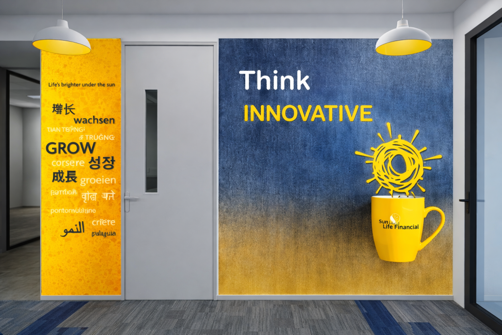 Corporate office interior featuring wall graphics reading “Think Innovative” alongside a large yellow mug illustration and multilingual growth-themed typography.