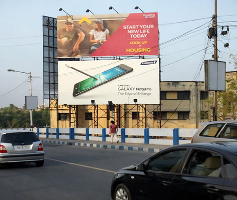 Stacked billboards promoting housing services and Samsung Galaxy Note Pro