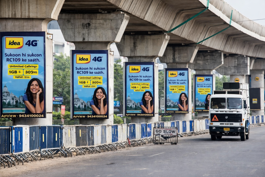 Multiple Idea 4G advertising panels mounted on pillars under a flyover beside a road