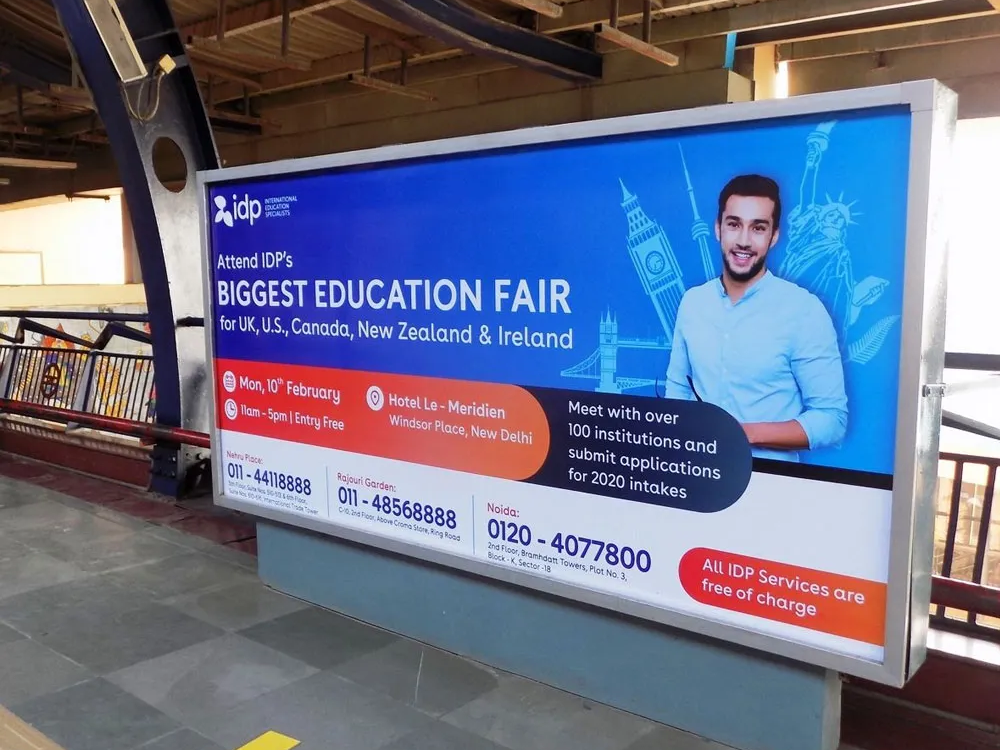 Large IDP Education Fair advertisement displayed inside a metro station corridor