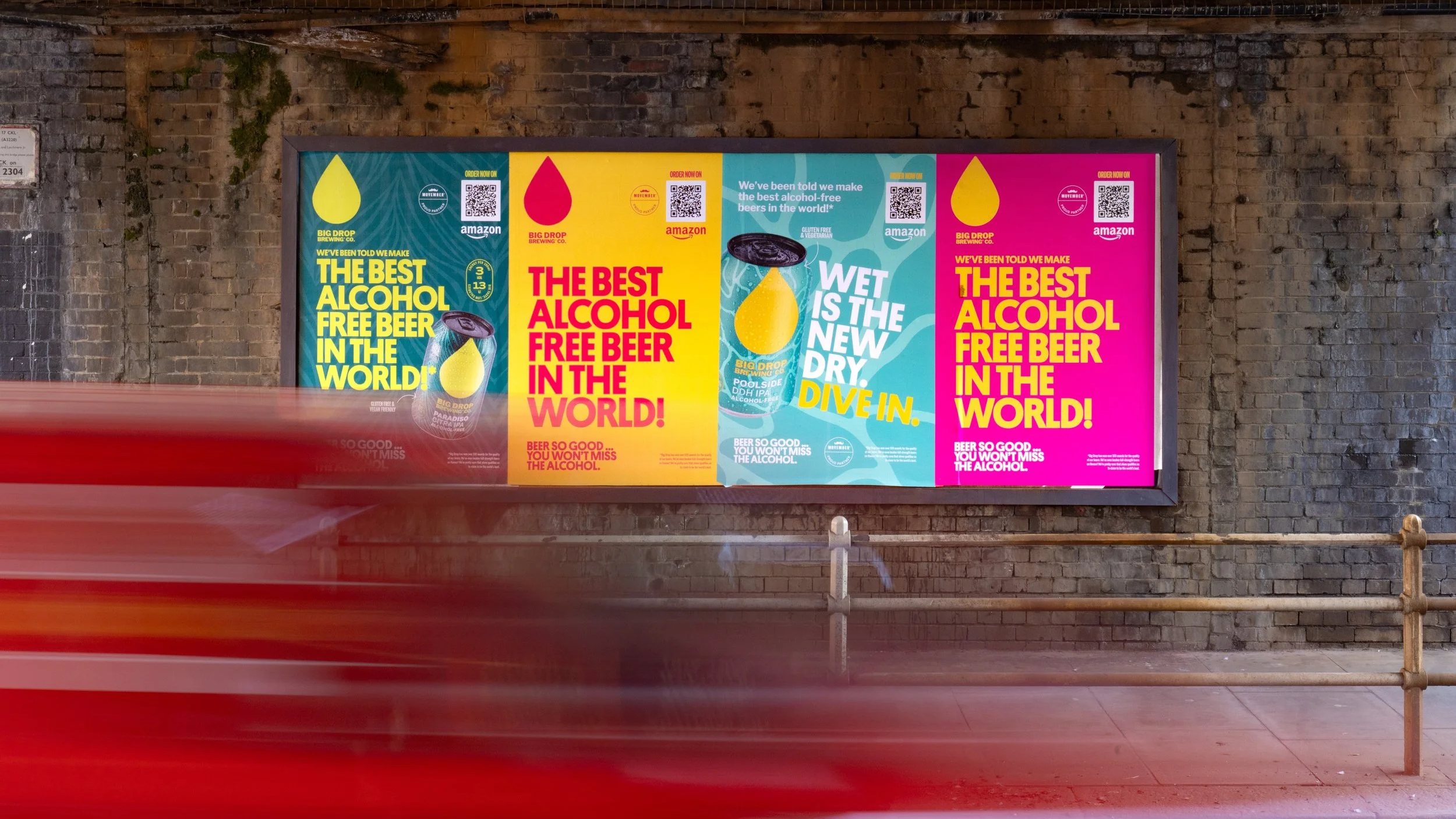 Colorful outdoor billboard campaign promoting alcohol-free beer with bold typography and motion blur of passing traffic