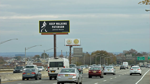 Johnnie Walker Keep Walking billboard on highway targeting drivers and commuters