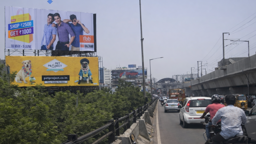 Fashion Big Bazaar and Pet Project billboards displayed along busy urban road with traffic