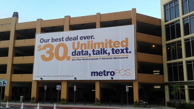 MetroPCS billboard promoting unlimited data plan on building facade in urban area