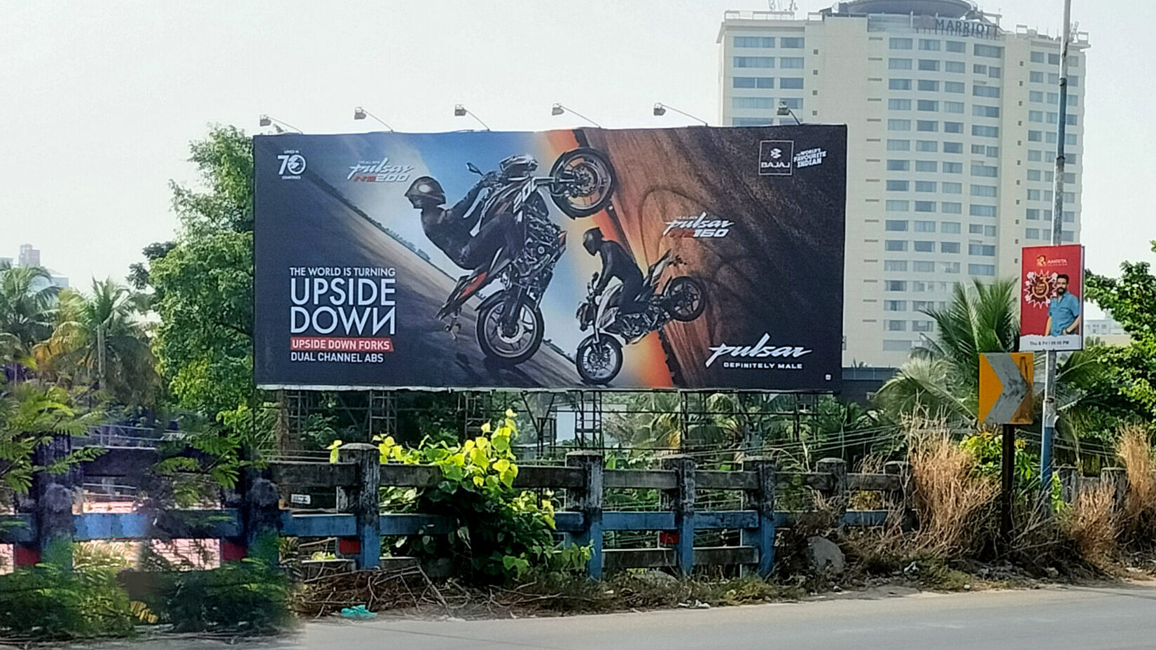 Bajaj Pulsar motorcycle billboard featuring stunt visuals and upside down concept advertising
