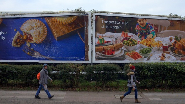 Food billboard showing family meal scene with “potato ninja strikes again” creative messaging