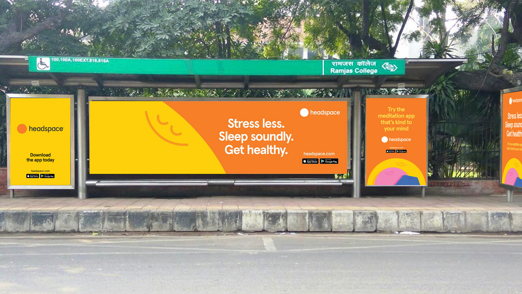 Headspace meditation app advertising displayed across multiple panels at a bus shelter near Ramjas College encouraging people to stress less and sleep better.