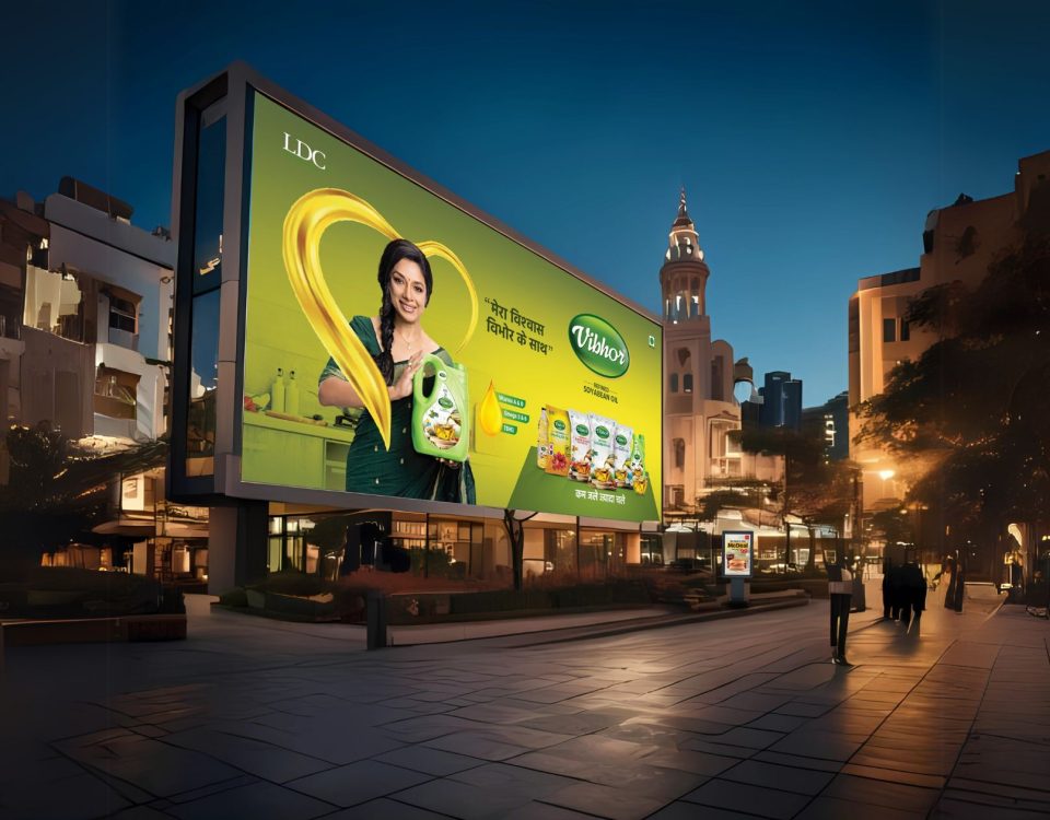 Large outdoor billboard advertising cooking oil brand in a city street at night with illuminated hoarding and high visibility placement